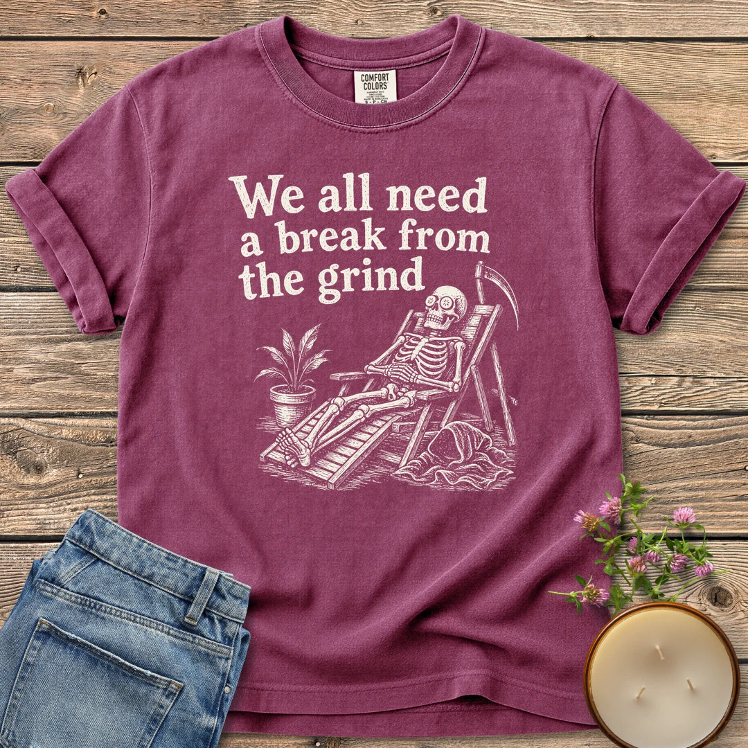 A Break From the Grind t-shirt, a skeleton relaxing in a beach chair with a houseplant under We all need a break from the grind, on a Berry Comfort Colors tee