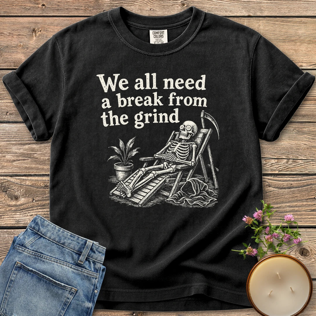 A Break From the Grind t-shirt, a skeleton relaxing in a beach chair with a houseplant under We all need a break from the grind, on a Black Comfort Colors tee