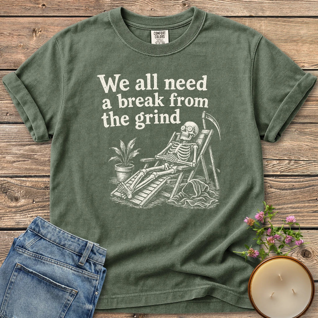 A Break From the Grind t-shirt, a skeleton relaxing in a beach chair with a houseplant under We all need a break from the grind, on a Moss Comfort Colors tee