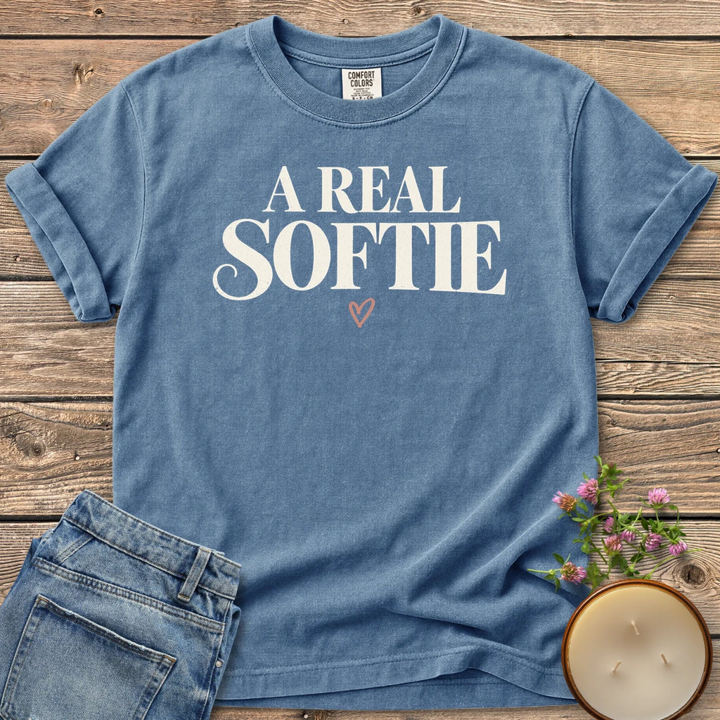 A Real Softie Vintage t-shirt, A Real Softie in vintage serif type with a small heart, on a Blue Jean Comfort Colors tee