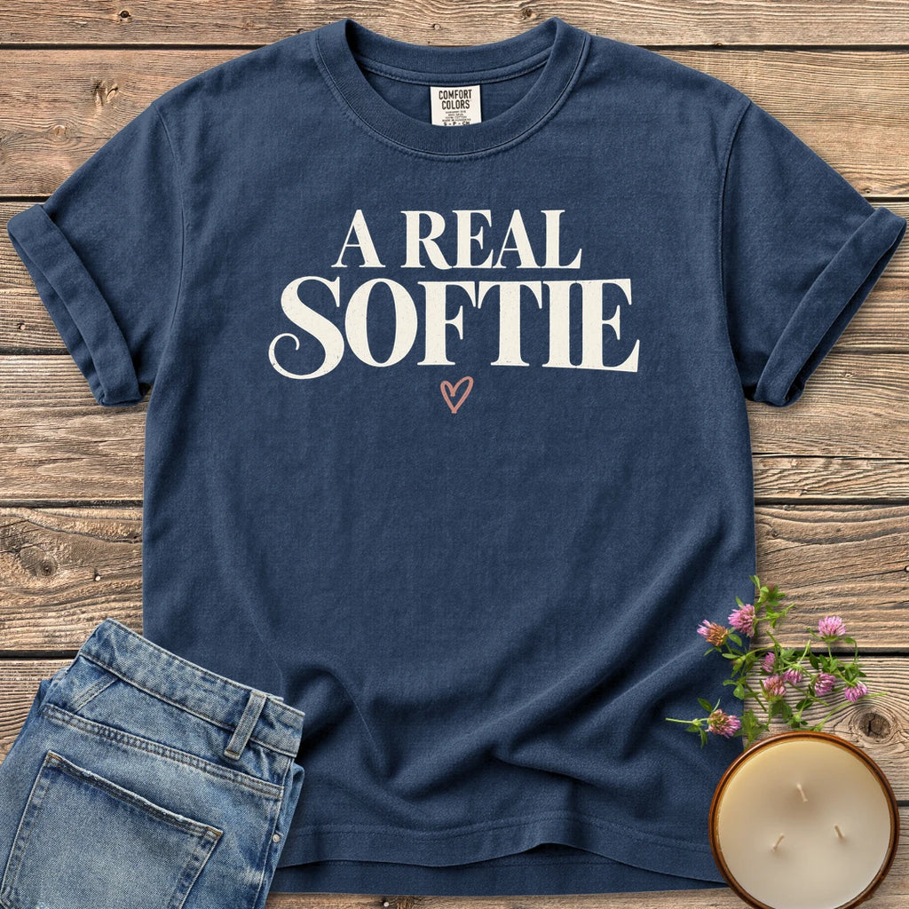 A Real Softie Vintage t-shirt, A Real Softie in vintage serif type with a small heart, on a Navy Comfort Colors tee