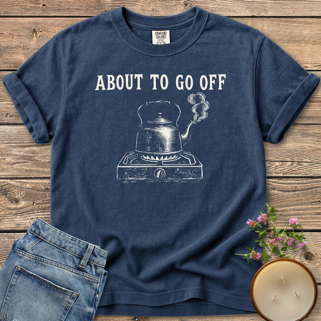 About to Go Off t-shirt, a whistling tea kettle on a burner under About To Go Off, on a Navy Comfort Colors tee