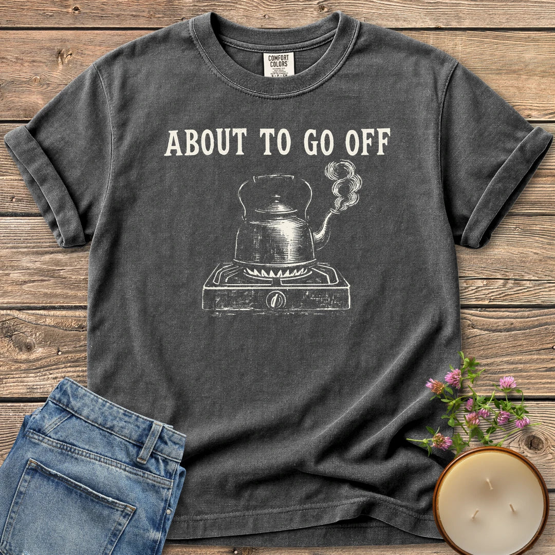 About to Go Off t-shirt, a whistling tea kettle on a burner under About To Go Off, on a Pepper Comfort Colors tee
