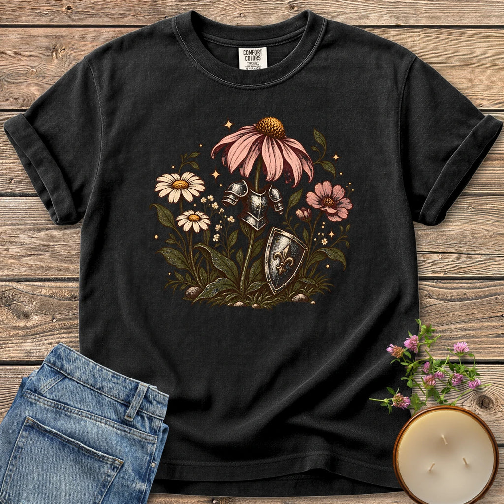 Armored Flower Knight t-shirt, pink coneflowers and daisies wearing a knight's armor and shield, on a Black Comfort Colors tee