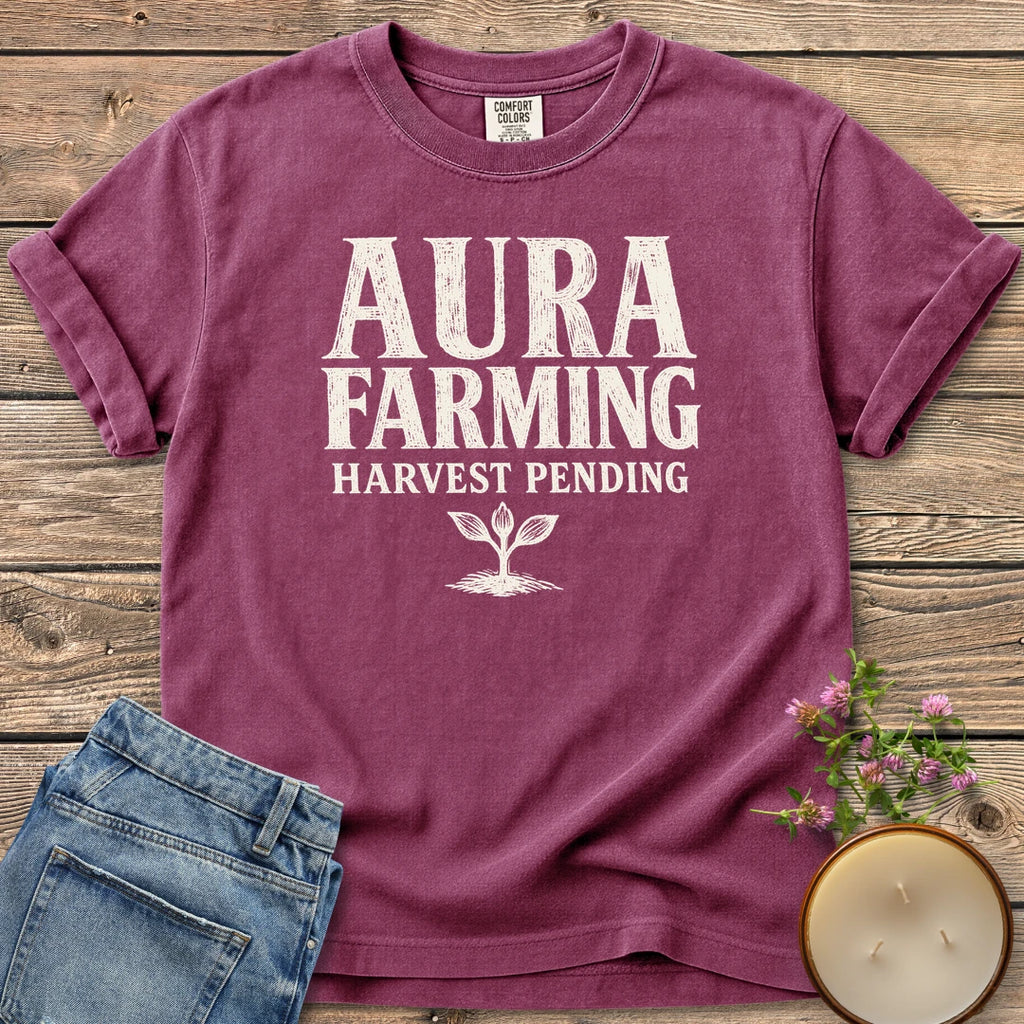 Aura Farming Harvest Pending t-shirt, Aura Farming in woodcut letters with Harvest Pending and a small sprout, on a Berry Comfort Colors tee