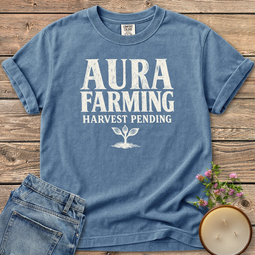 Aura Farming Harvest Pending t-shirt, Aura Farming in woodcut letters with Harvest Pending and a small sprout, on a Blue Jean Comfort Colors tee