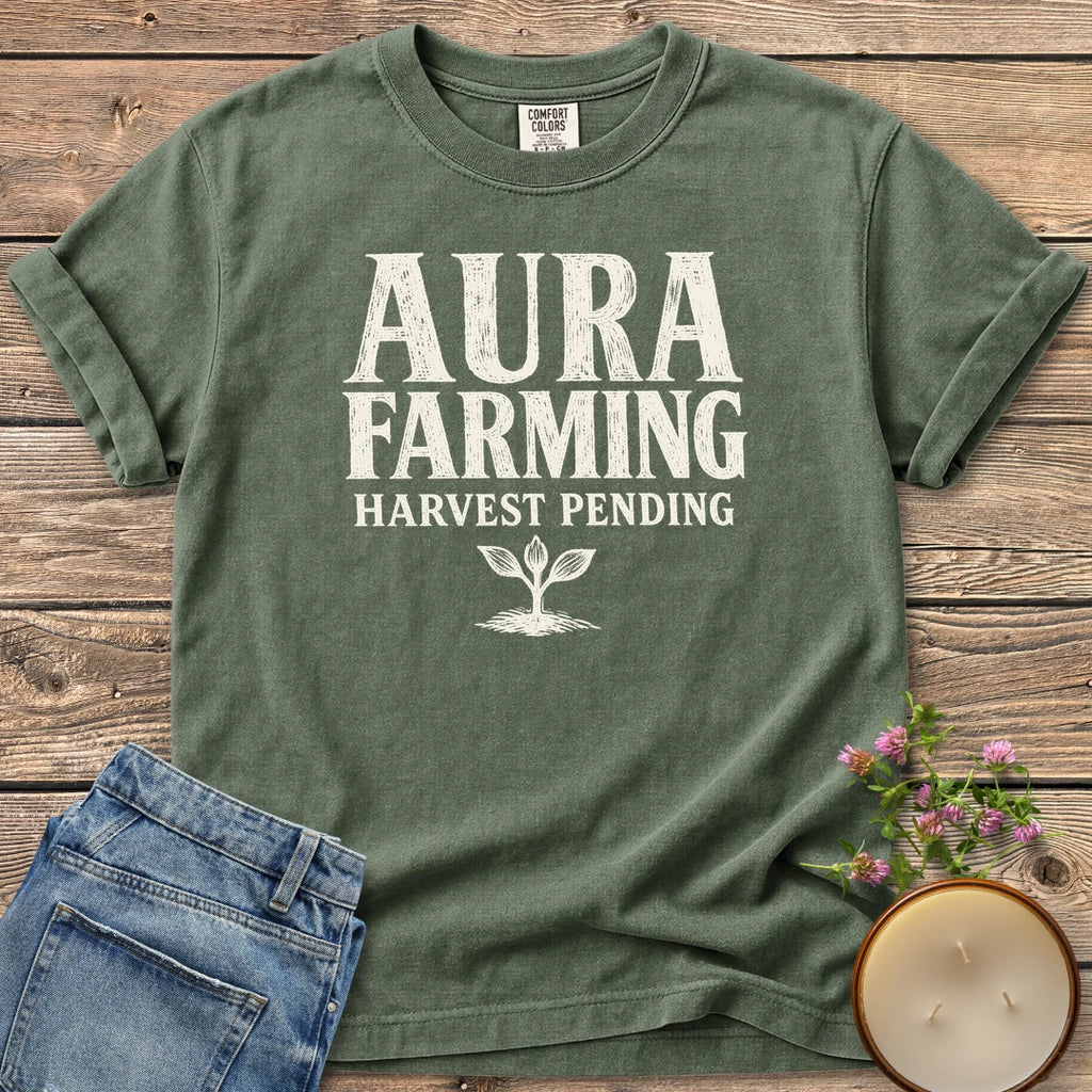 Aura Farming Harvest Pending t-shirt, Aura Farming in woodcut letters with Harvest Pending and a small sprout, on a Moss Comfort Colors tee