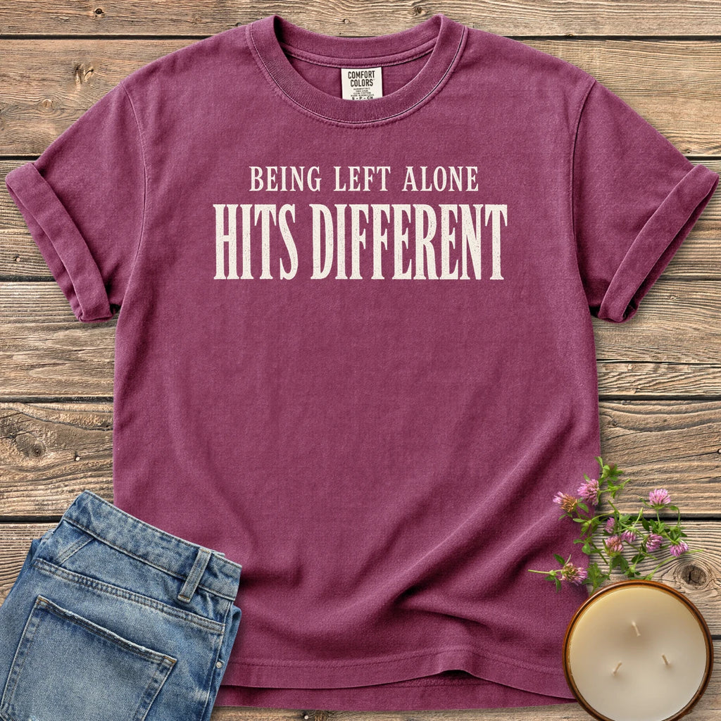 Being Left Alone Hits Different t-shirt, Being Left Alone Hits Different in distressed vintage type, on a Berry Comfort Colors tee