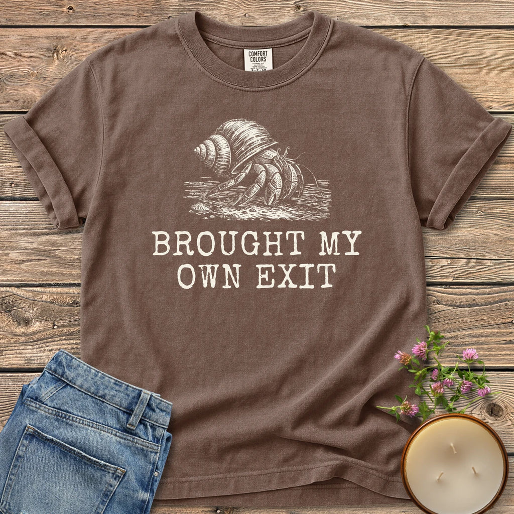 Brought My Own Exit t-shirt, a hermit crab carrying its shell above Brought My Own Exit, on an Espresso Comfort Colors tee