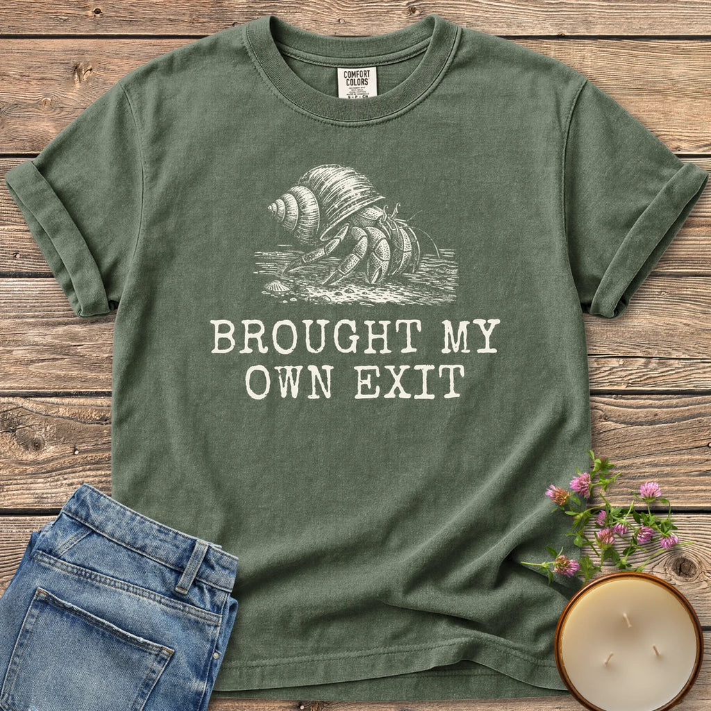 Brought My Own Exit t-shirt, a hermit crab carrying its shell above Brought My Own Exit, on a Moss Comfort Colors tee