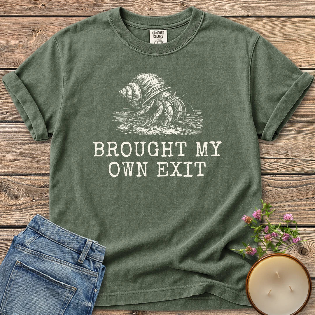 Brought My Own Exit t-shirt, a hermit crab carrying its shell above Brought My Own Exit, on a Moss Comfort Colors tee