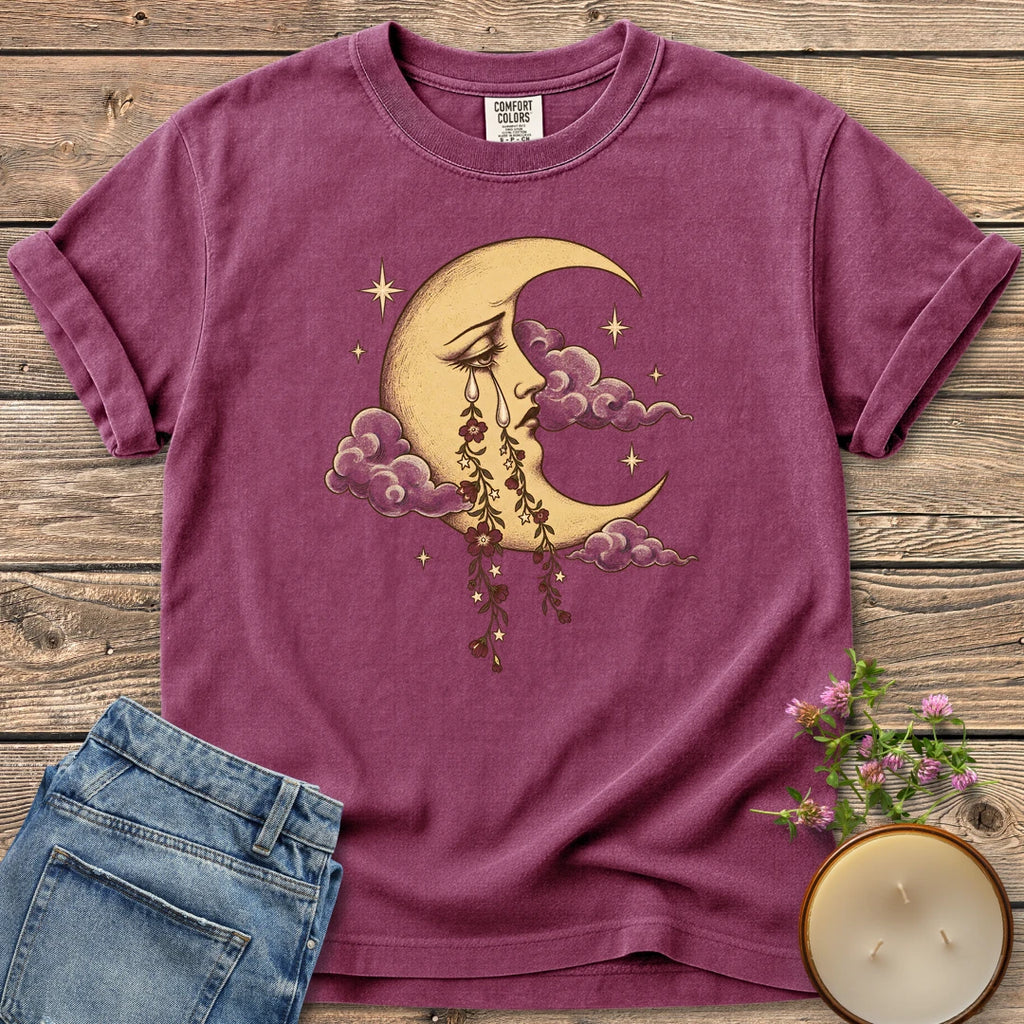 Crescent Moon Floral Tears t-shirt, a crescent moon crying tears of hanging flowers among clouds and stars, on a Berry Comfort Colors tee