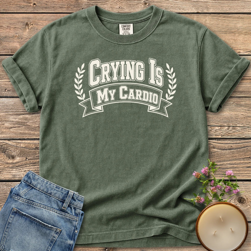 Crying Is My Cardio t-shirt, Crying Is My Cardio in varsity letters on a banner with laurel branches, on a Moss Comfort Colors tee