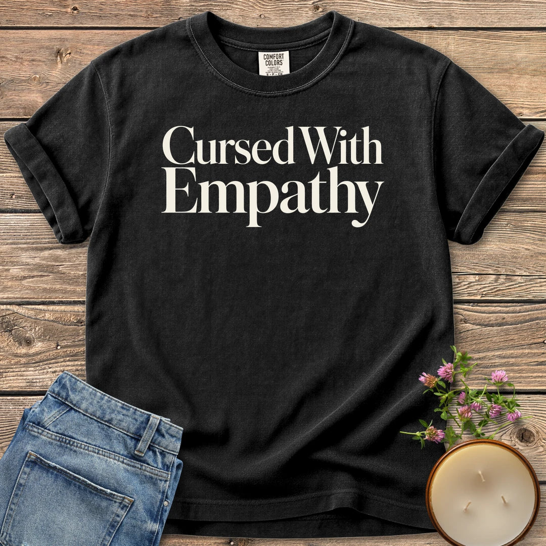 Cursed With Empathy t-shirt, Cursed With Empathy in elegant serif type, on a Black Comfort Colors tee