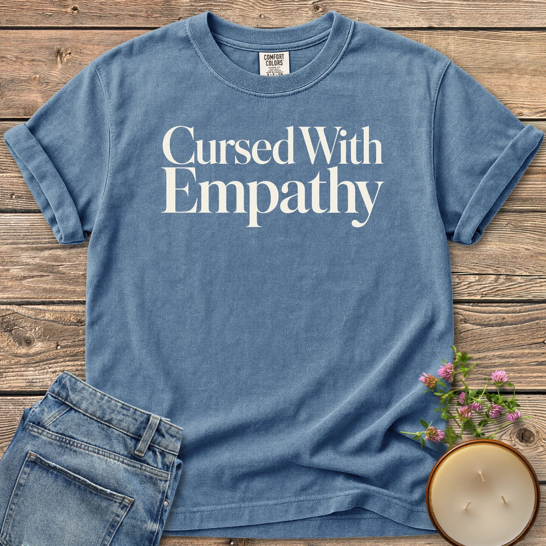 Cursed With Empathy t-shirt, Cursed With Empathy in elegant serif type, on a Blue Jean Comfort Colors tee