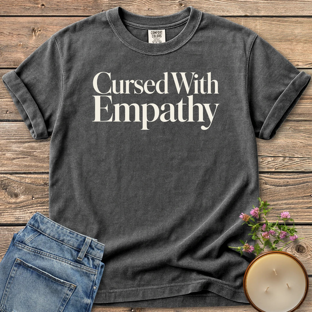 Cursed With Empathy t-shirt, Cursed With Empathy in elegant serif type, on a Pepper Comfort Colors tee
