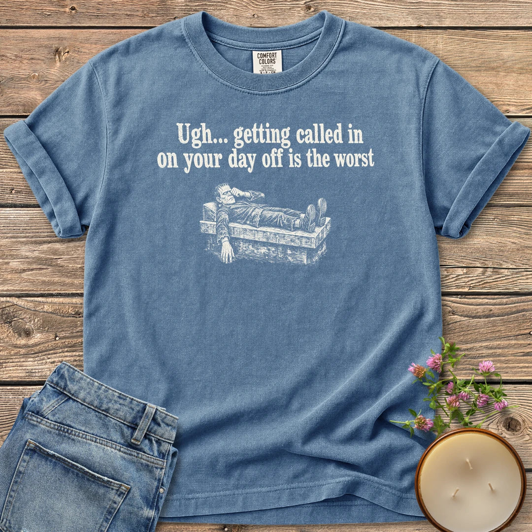 Day Off Is the Worst t-shirt, Frankenstein's monster lying flat on a slab under Ugh... getting called in on your day off is the worst, on a Blue Jean Comfort Colors tee