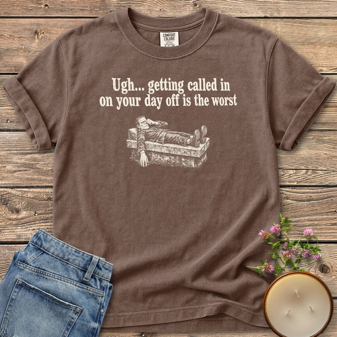 Day Off Is the Worst t-shirt, Frankenstein's monster lying flat on a slab under Ugh... getting called in on your day off is the worst, on an Espresso Comfort Colors tee