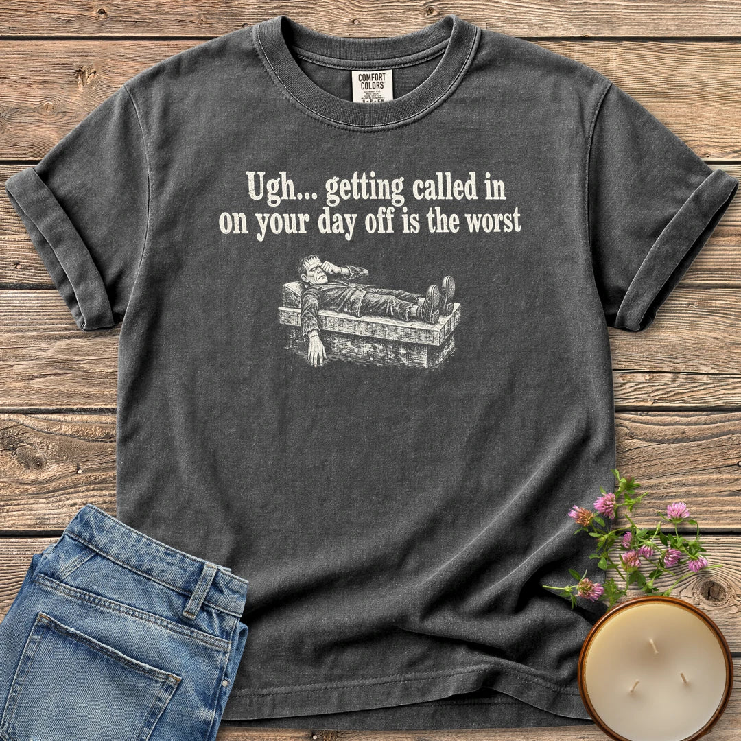 Day Off Is the Worst t-shirt, Frankenstein's monster lying flat on a slab under Ugh... getting called in on your day off is the worst, on a Pepper Comfort Colors tee