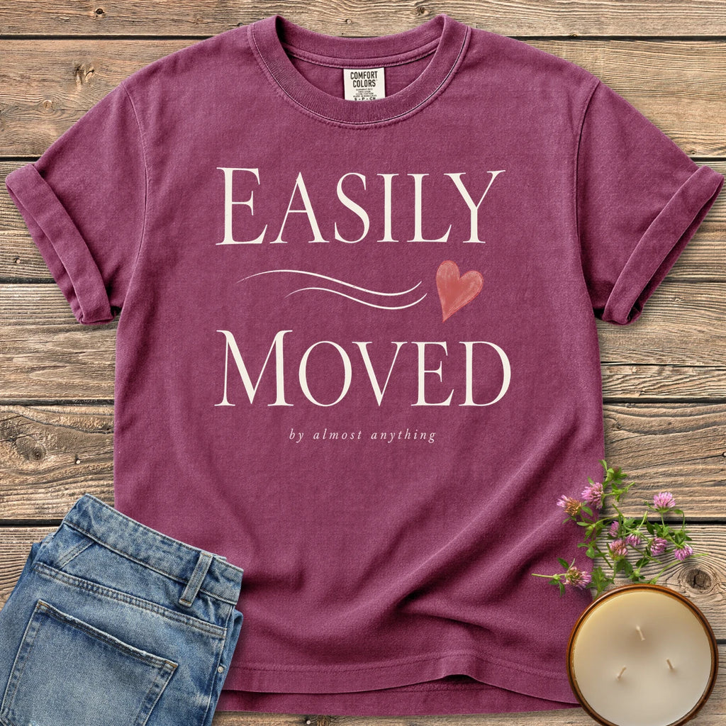 Easily Moved By Almost Anything t-shirt, Easily Moved in elegant serif type with a heart and by almost anything, on a Berry Comfort Colors tee