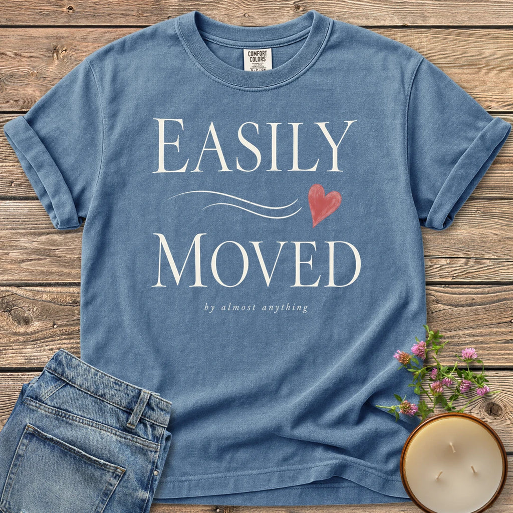 Easily Moved By Almost Anything t-shirt, Easily Moved in elegant serif type with a heart and by almost anything, on a Blue Jean Comfort Colors tee