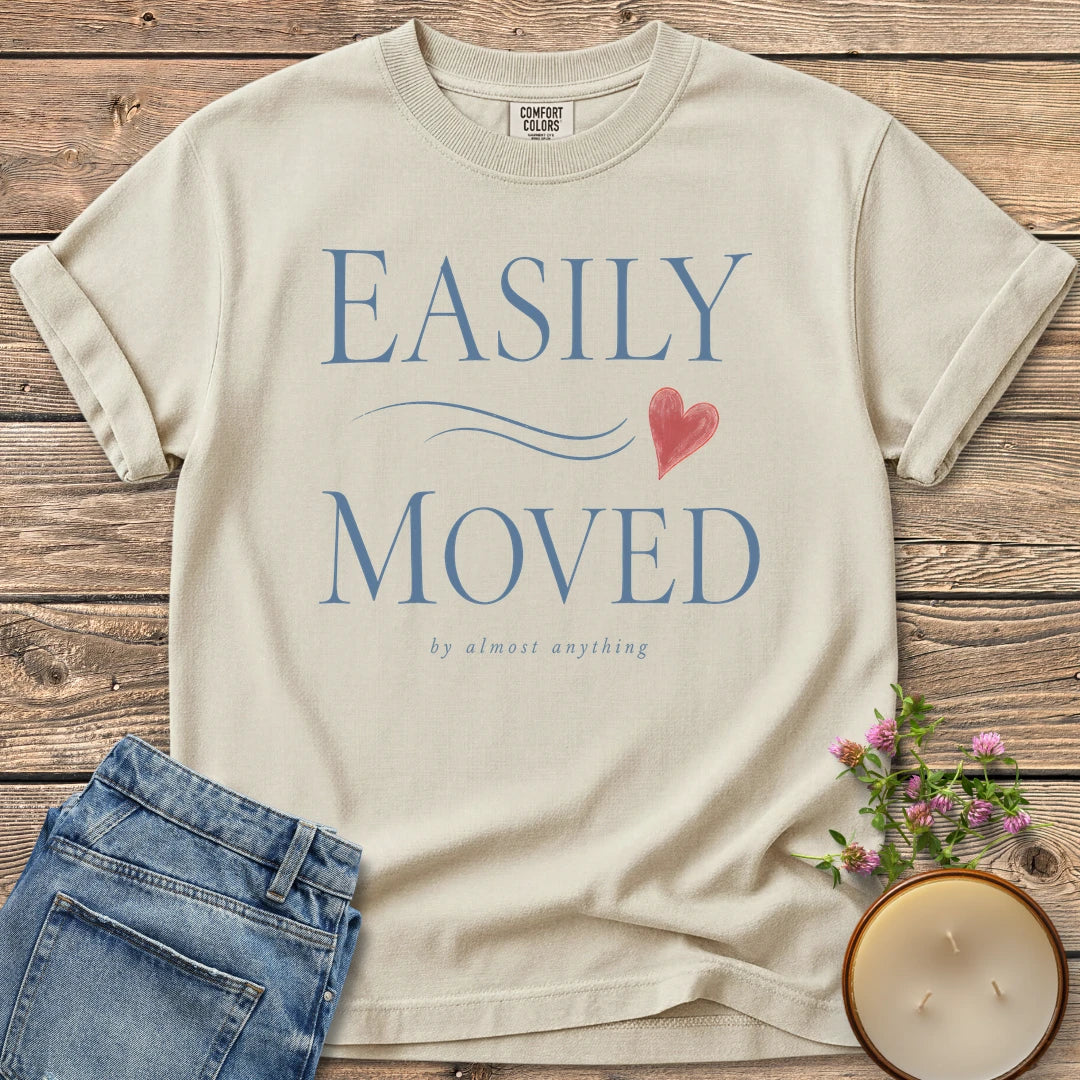 Easily Moved By Almost Anything t-shirt, Easily Moved in elegant serif type with a heart and by almost anything, on an Ivory Comfort Colors tee