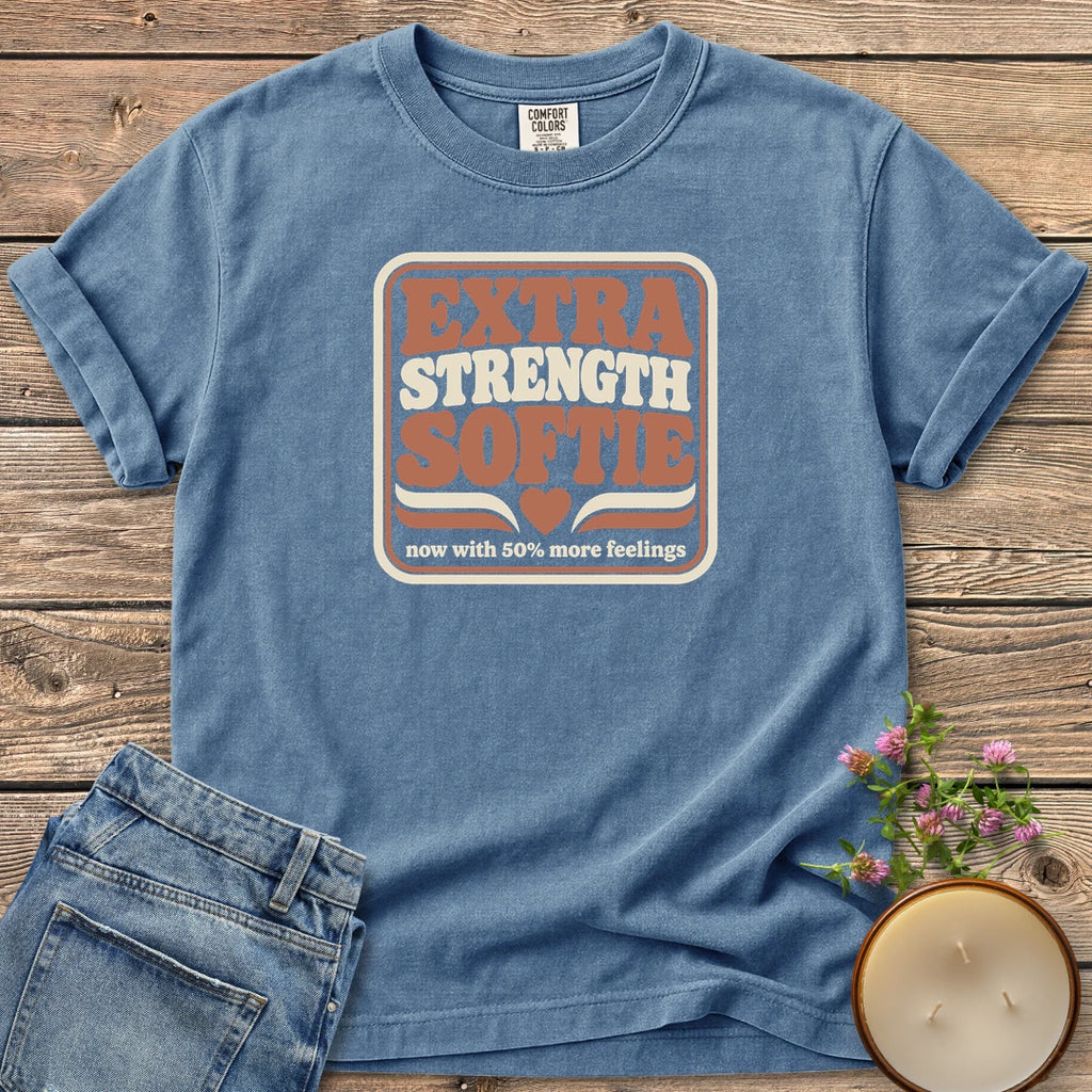 Extra Strength Softie t-shirt, a retro badge reading Extra Strength Softie with a heart and now with 50% more feelings, on a Blue Jean Comfort Colors tee