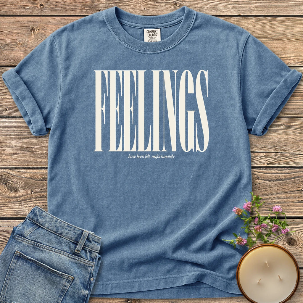 Feelings Unfortunately t-shirt, FEELINGS in tall condensed type with have been felt, unfortunately, on a Blue Jean Comfort Colors tee