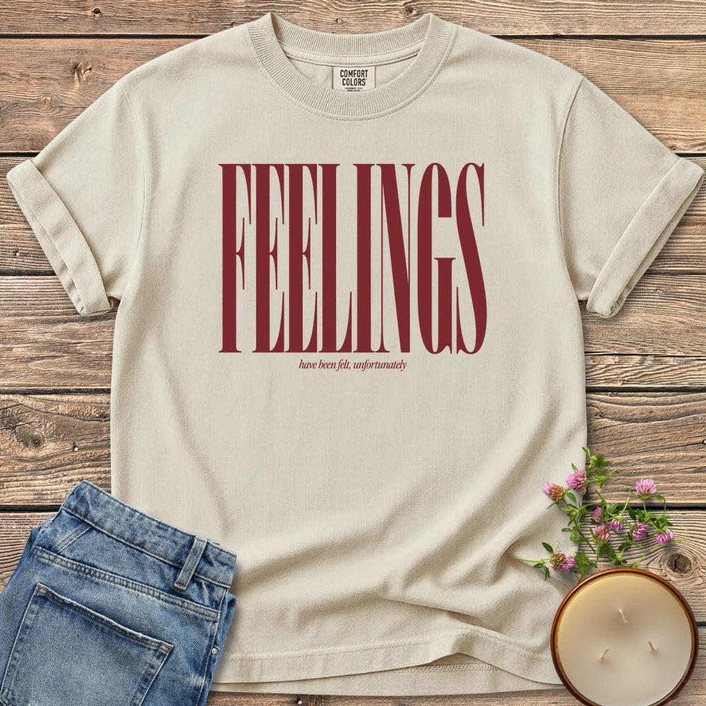 Feelings Unfortunately t-shirt, FEELINGS in tall condensed type with have been felt, unfortunately, on an Ivory Comfort Colors tee