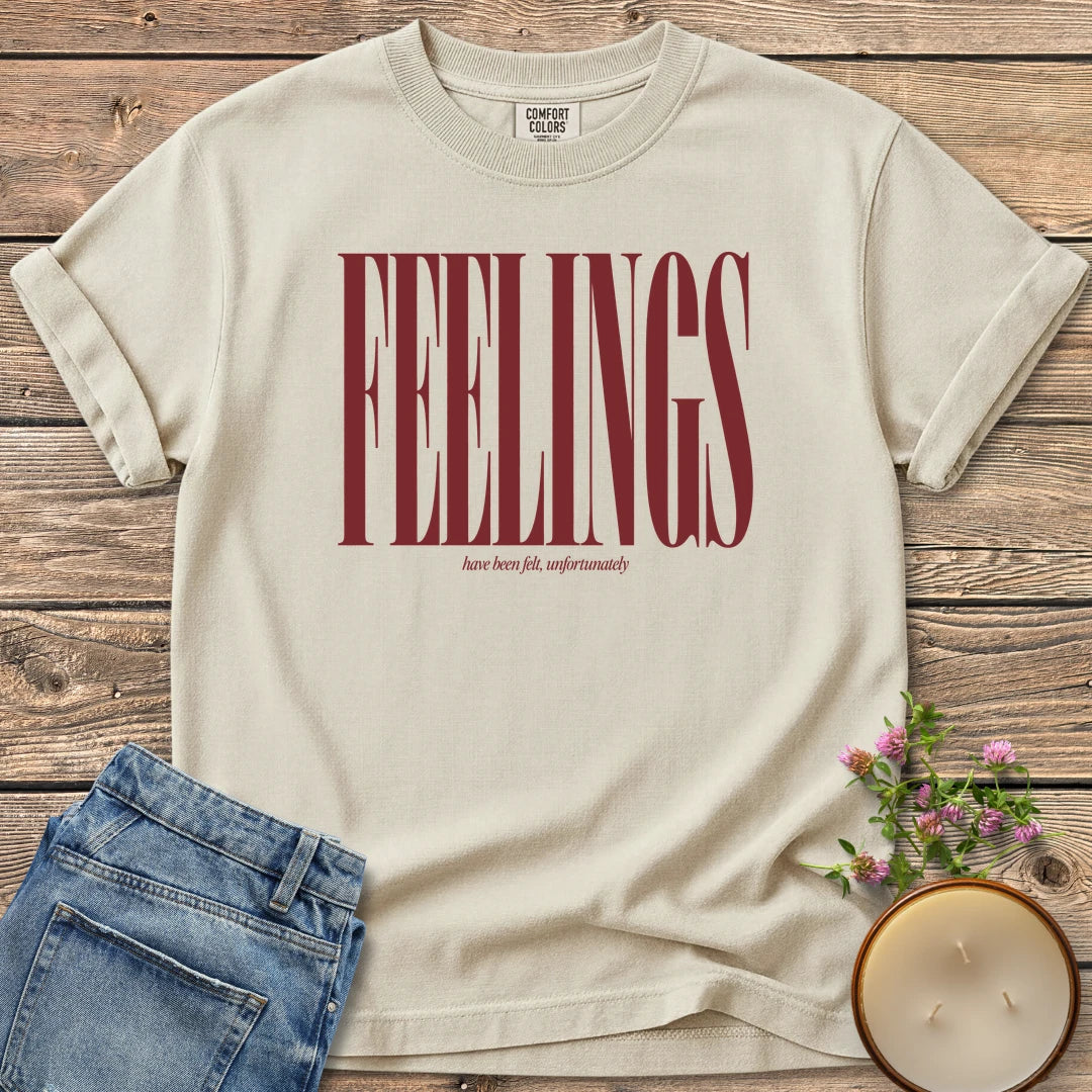 Feelings Unfortunately t-shirt, FEELINGS in tall condensed type with have been felt, unfortunately, on an Ivory Comfort Colors tee