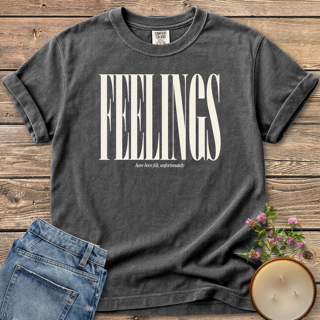 Feelings Unfortunately t-shirt, FEELINGS in tall condensed type with have been felt, unfortunately, on a Pepper Comfort Colors tee