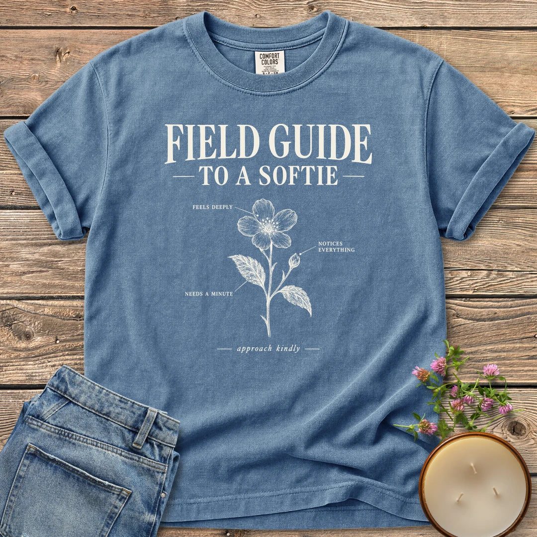 Field Guide To A Softie t-shirt, Field Guide To A Softie with a labeled flower reading feels deeply, notices everything, needs a minute, on a Blue Jean Comfort Colors tee