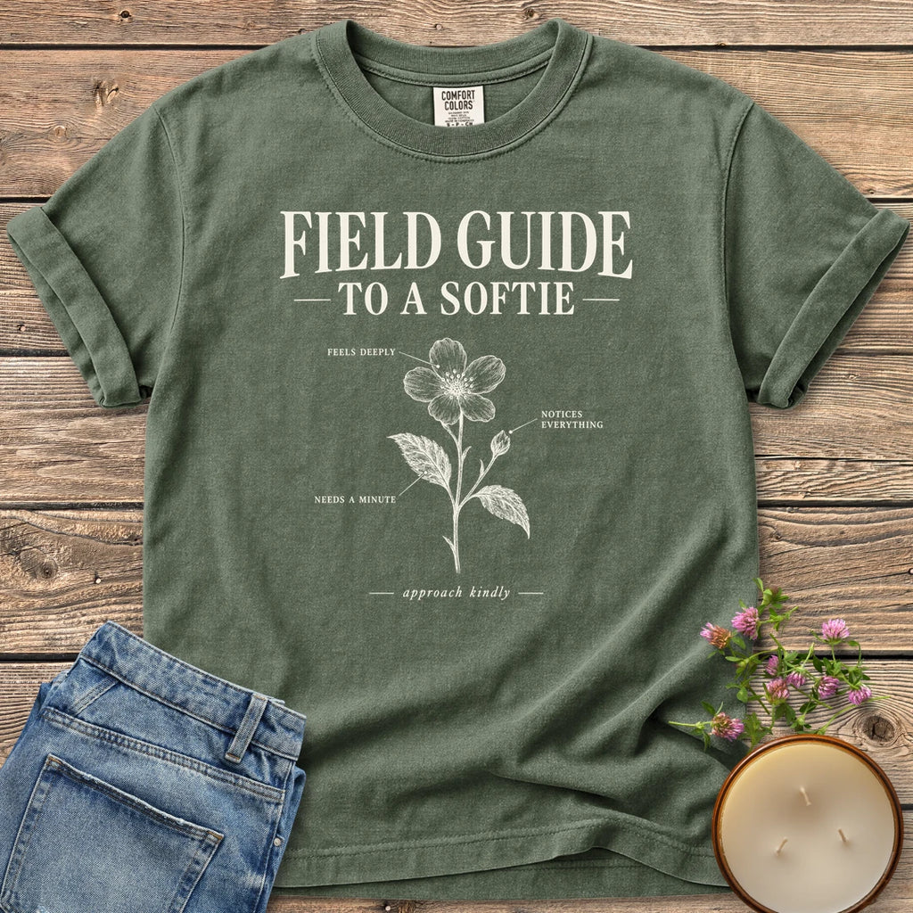 Field Guide To A Softie t-shirt, Field Guide To A Softie with a labeled flower reading feels deeply, notices everything, needs a minute, on a Moss Comfort Colors tee