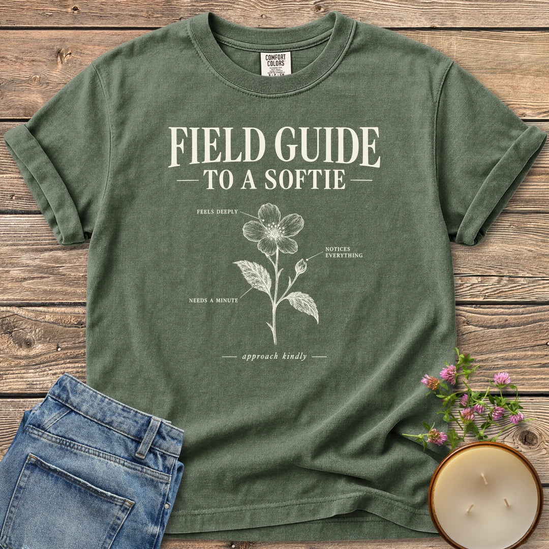 Field Guide To A Softie t-shirt, Field Guide To A Softie with a labeled flower reading feels deeply, notices everything, needs a minute, on a Moss Comfort Colors tee