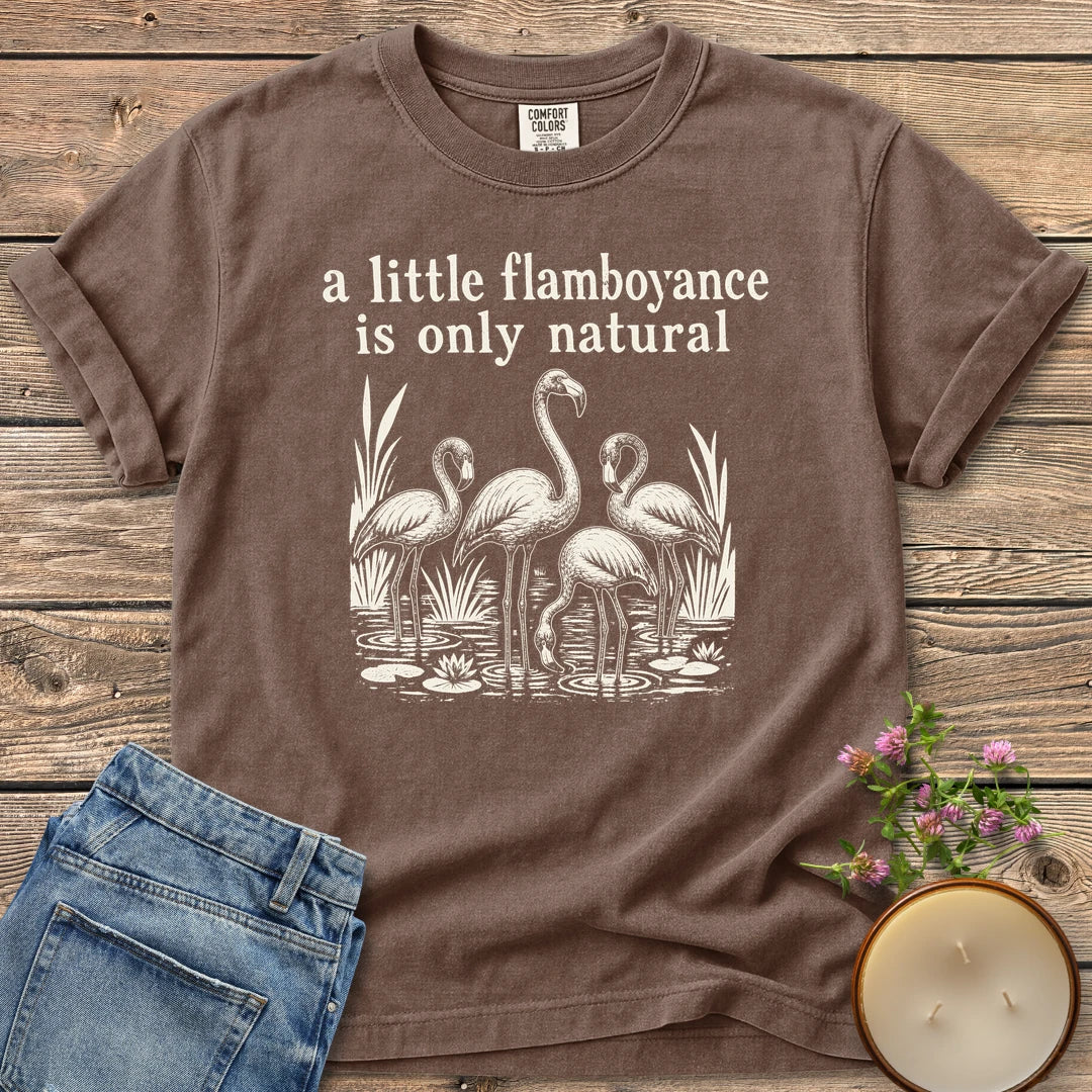 Flamboyance Is Only Natural t-shirt, a group of flamingos wading in a pond under a little flamboyance is only natural, on an Espresso Comfort Colors tee