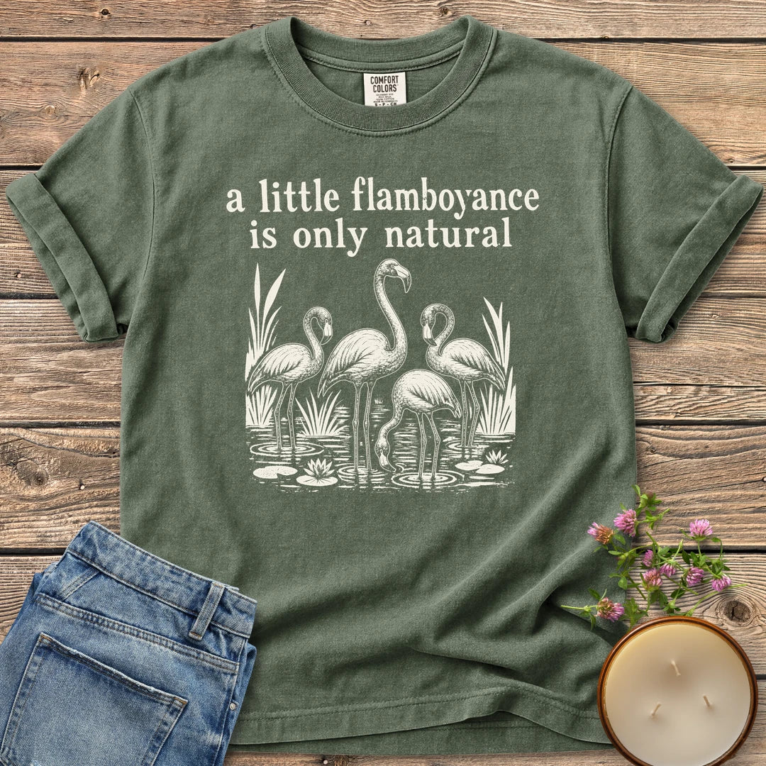 Flamboyance Is Only Natural t-shirt, a group of flamingos wading in a pond under a little flamboyance is only natural, on a Moss Comfort Colors tee