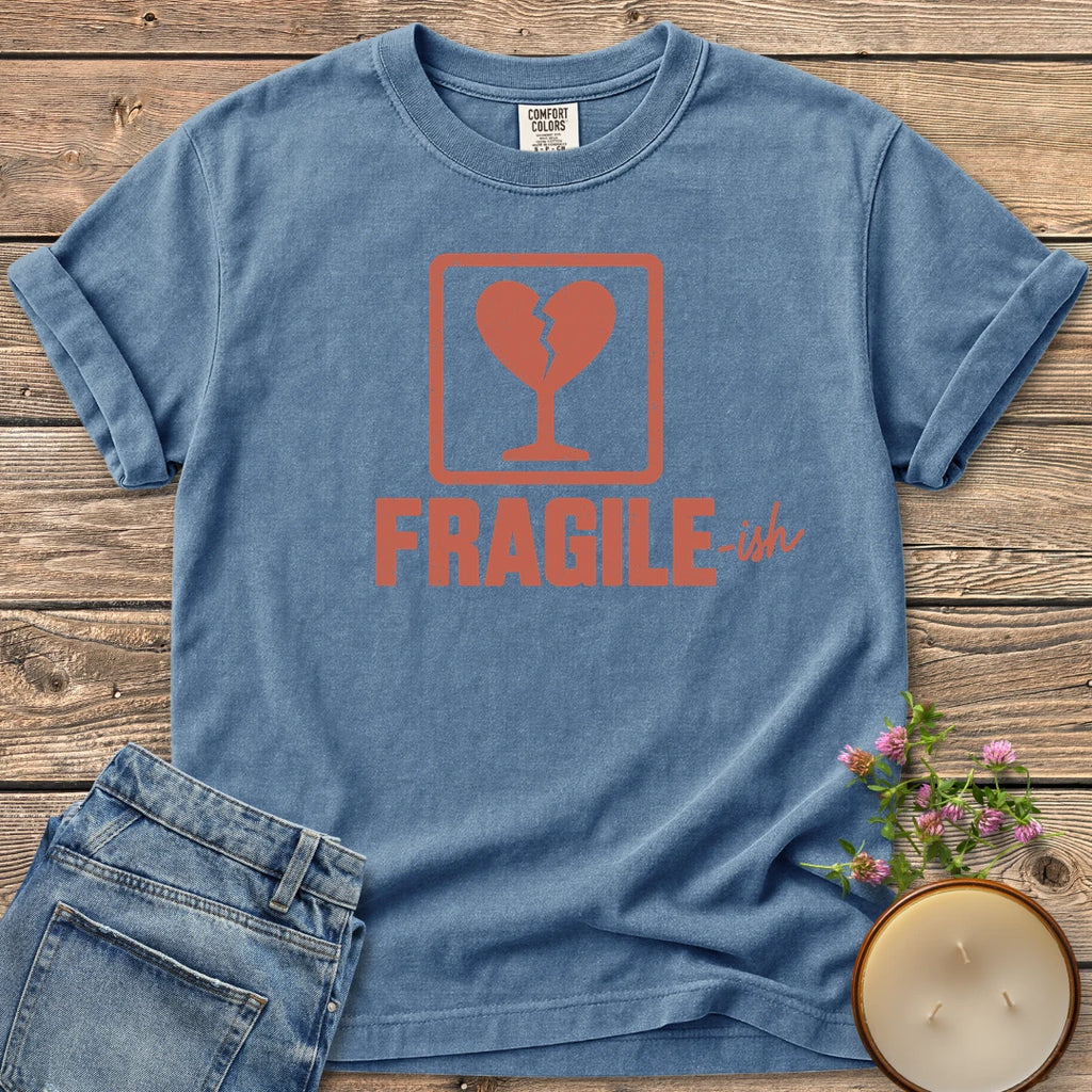 Fragile-ish t-shirt, a shipping label with a broken heart and cracked glass above Fragile-ish, on a Blue Jean Comfort Colors tee
