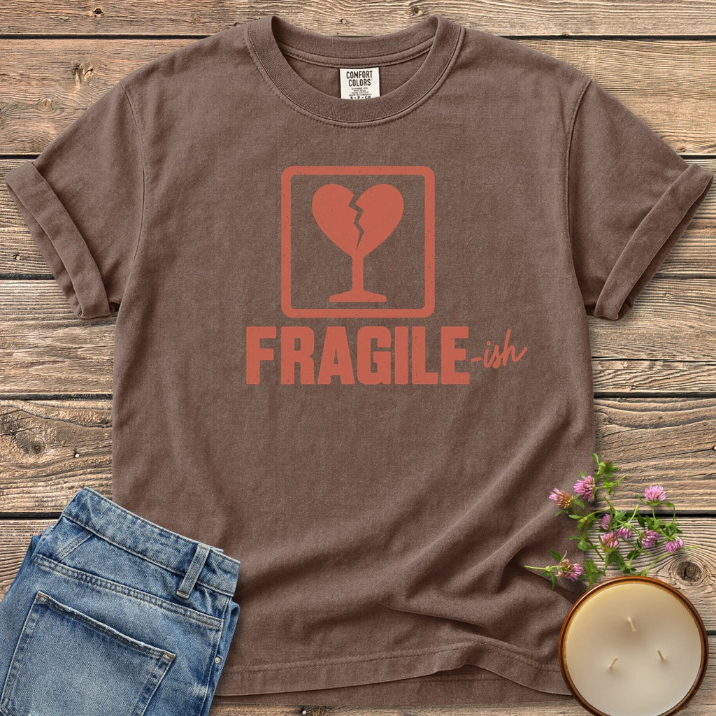 Fragile-ish t-shirt, a shipping label with a broken heart and cracked glass above Fragile-ish, on an Espresso Comfort Colors tee