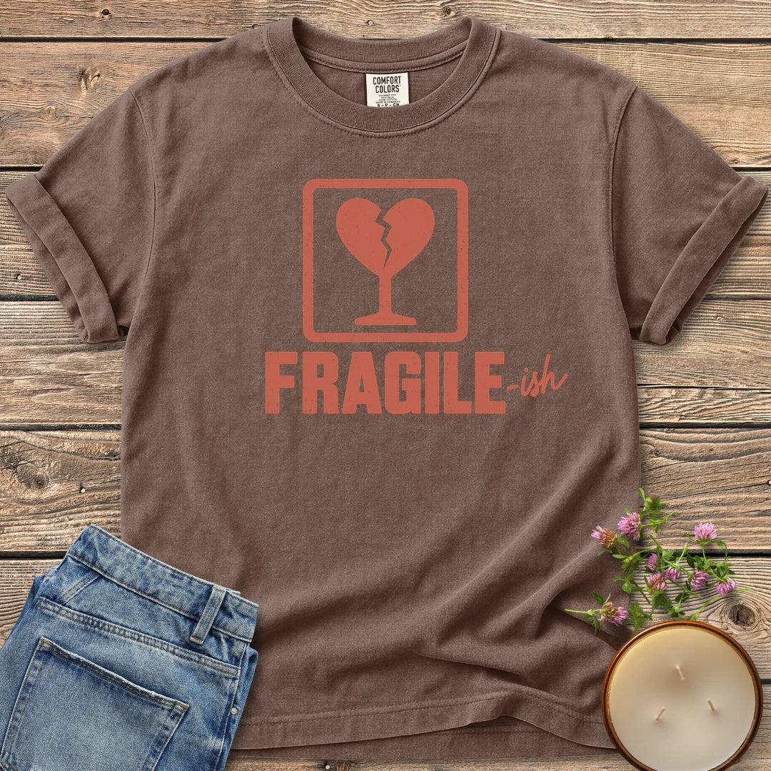 Fragile-ish t-shirt, a shipping label with a broken heart and cracked glass above Fragile-ish, on an Espresso Comfort Colors tee