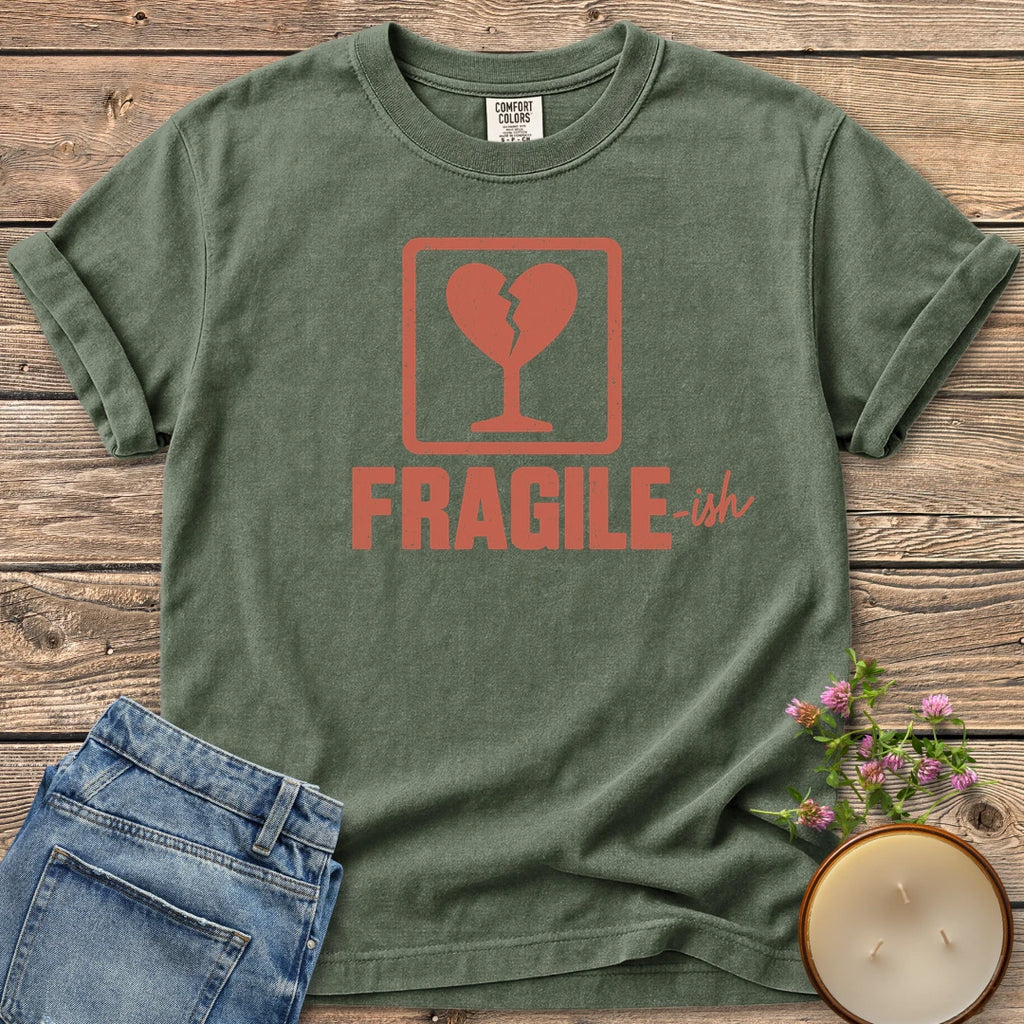 Fragile-ish t-shirt, a shipping label with a broken heart and cracked glass above Fragile-ish, on a Moss Comfort Colors tee