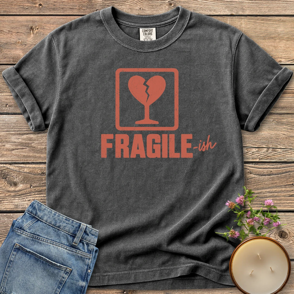 Fragile-ish t-shirt, a shipping label with a broken heart and cracked glass above Fragile-ish, on a Pepper Comfort Colors tee