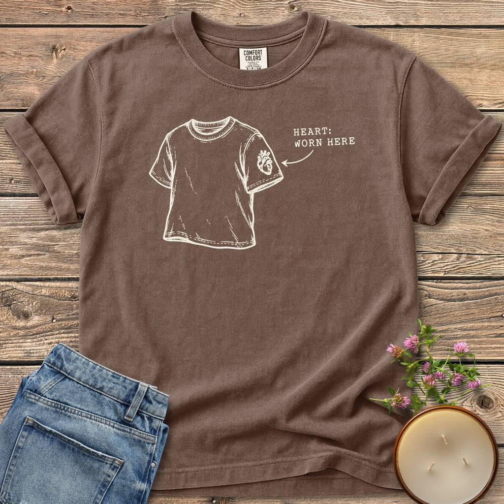 Heart Worn Here t-shirt, a sketched t-shirt with an anatomical heart on the sleeve and Heart: Worn Here, on an Espresso Comfort Colors tee