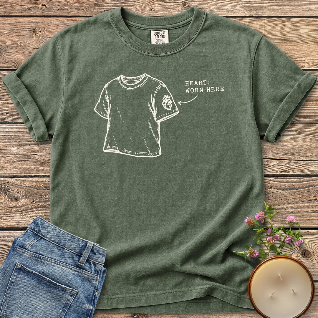 Heart Worn Here t-shirt, a sketched t-shirt with an anatomical heart on the sleeve and Heart: Worn Here, on a Moss Comfort Colors tee