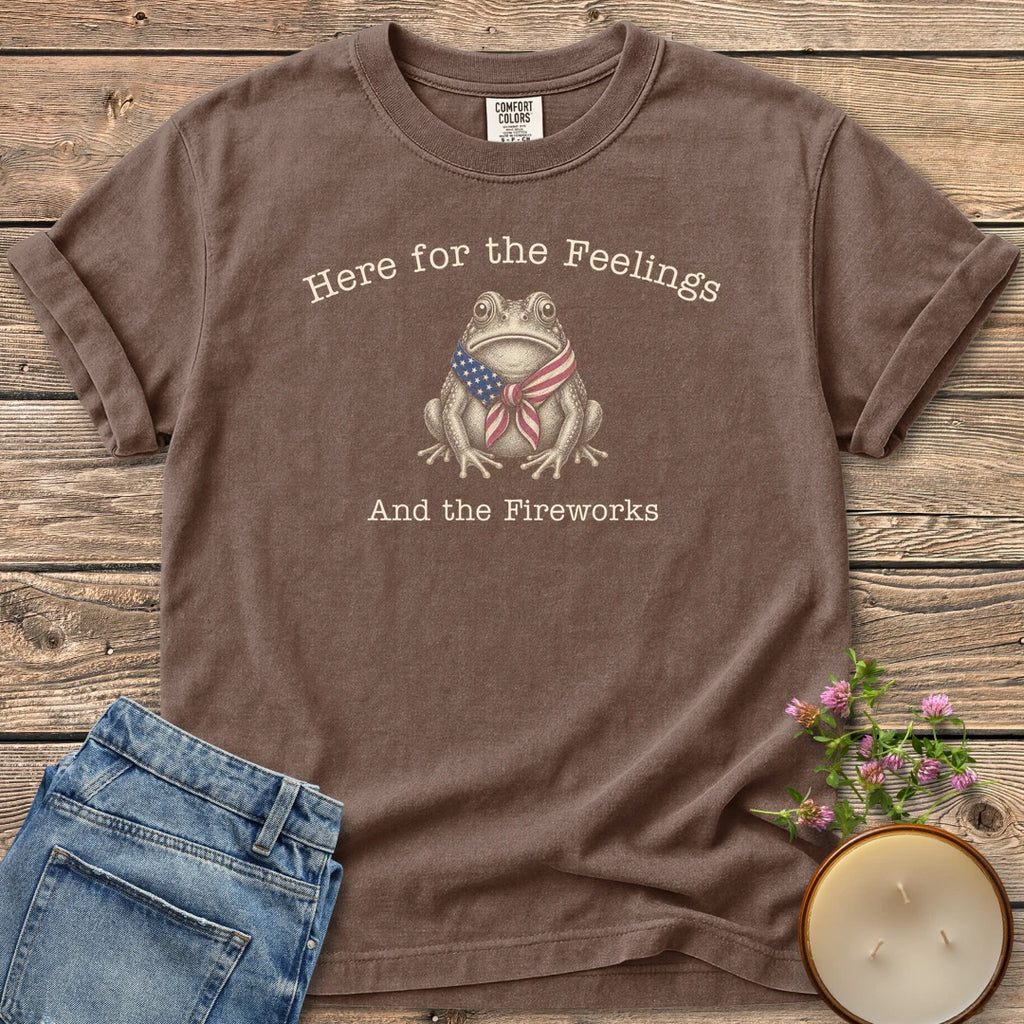 Here for the Feelings t-shirt, a toad in a stars and stripes bandana between Here for the Feelings and And the Fireworks, on an Espresso Comfort Colors tee