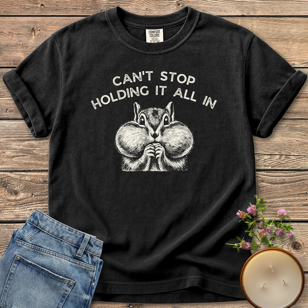 Holding It All In t-shirt, a chipmunk with puffed cheeks under Can't Stop Holding It All In, on a Black Comfort Colors tee