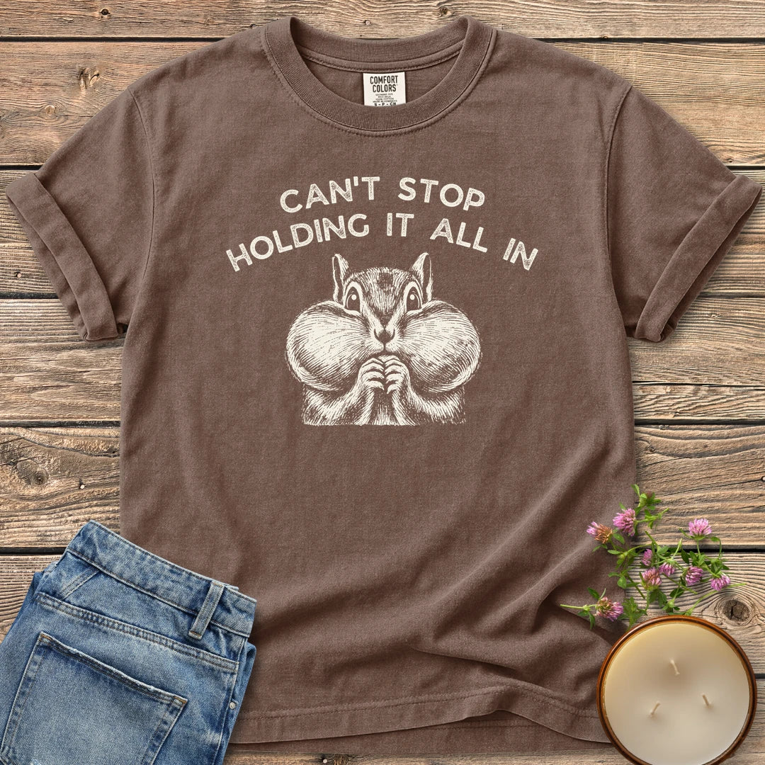 Holding It All In t-shirt, a chipmunk with puffed cheeks under Can't Stop Holding It All In, on an Espresso Comfort Colors tee