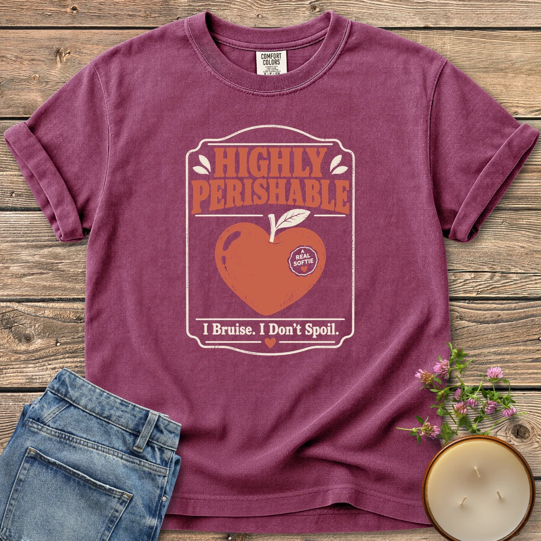 I Bruise I Don't Spoil t-shirt, a vintage label reading Highly Perishable with a heart-shaped apple and I Bruise. I Don't Spoil, on a Berry Comfort Colors tee