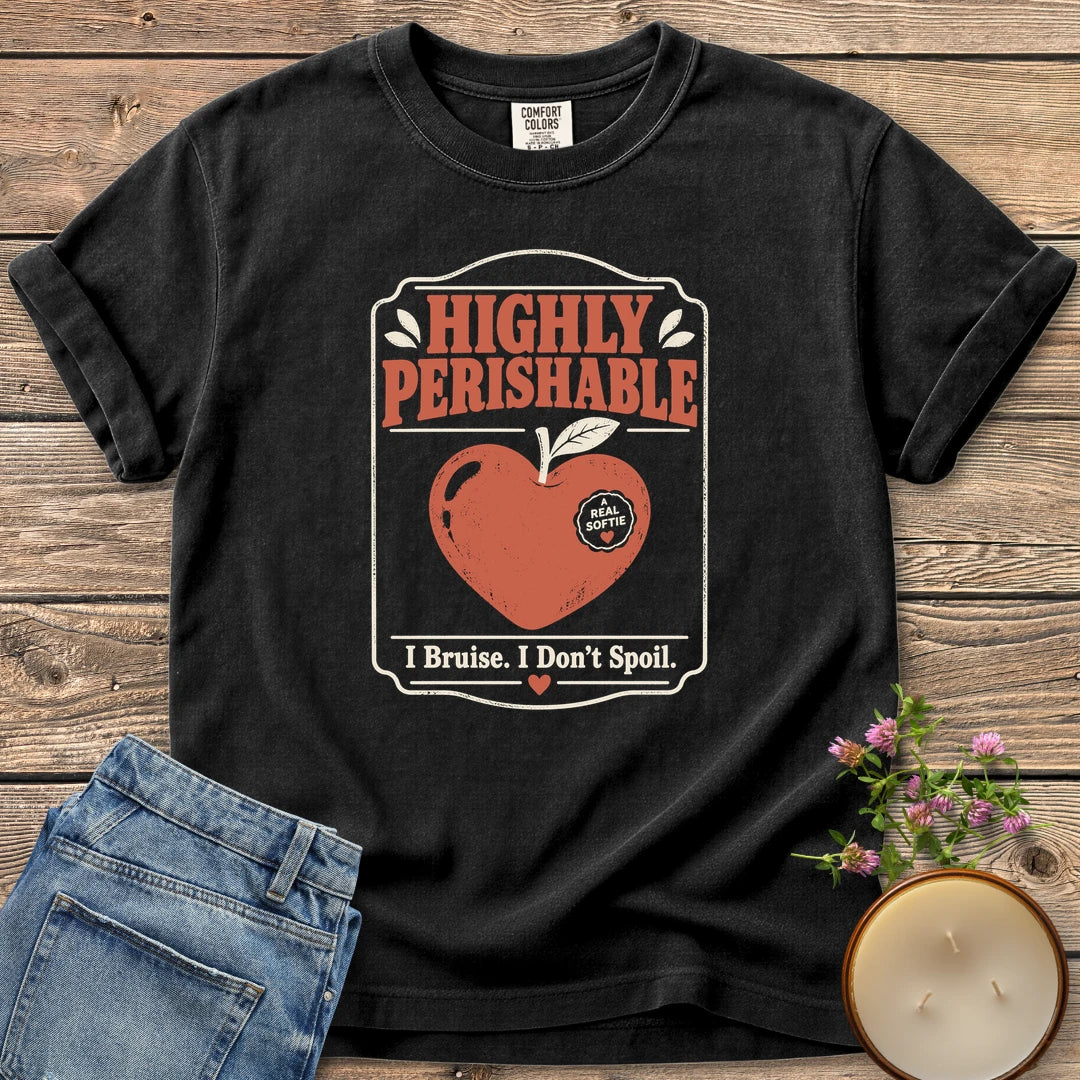I Bruise I Don't Spoil t-shirt, a vintage label reading Highly Perishable with a heart-shaped apple and I Bruise. I Don't Spoil, on a Black Comfort Colors tee