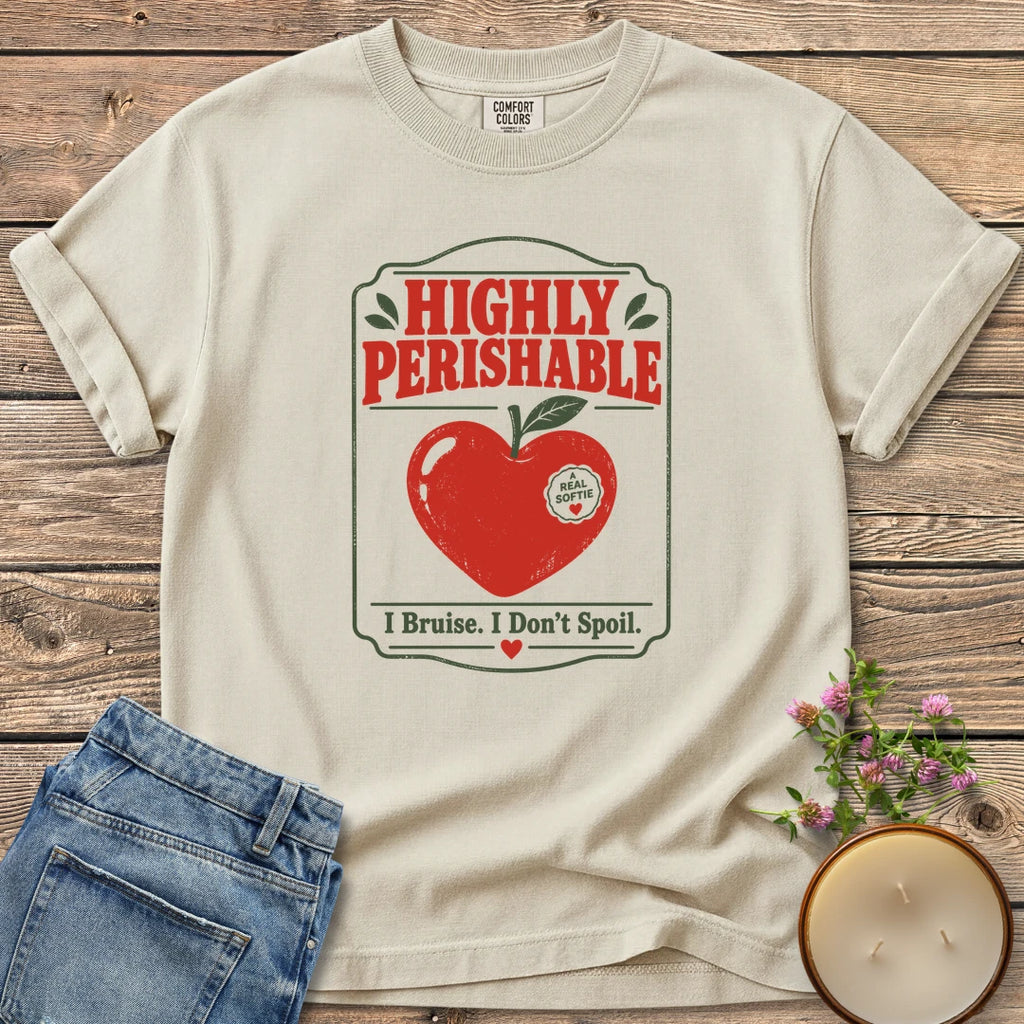 I Bruise I Don't Spoil t-shirt, a vintage label reading Highly Perishable with a heart-shaped apple and I Bruise. I Don't Spoil, on an Ivory Comfort Colors tee
