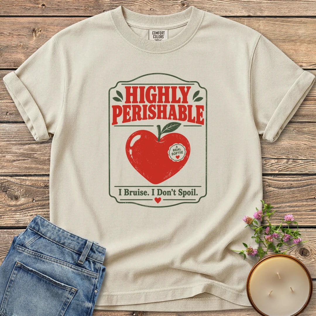 I Bruise I Don't Spoil t-shirt, a vintage label reading Highly Perishable with a heart-shaped apple and I Bruise. I Don't Spoil, on an Ivory Comfort Colors tee